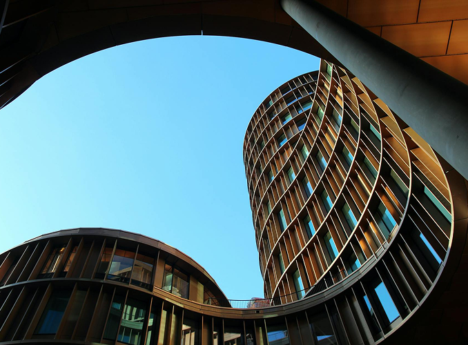 Architecturally distinct circular glass buildings against a clear blue sky, symbolizing transparency and strategic design at Point2 Capital Partners