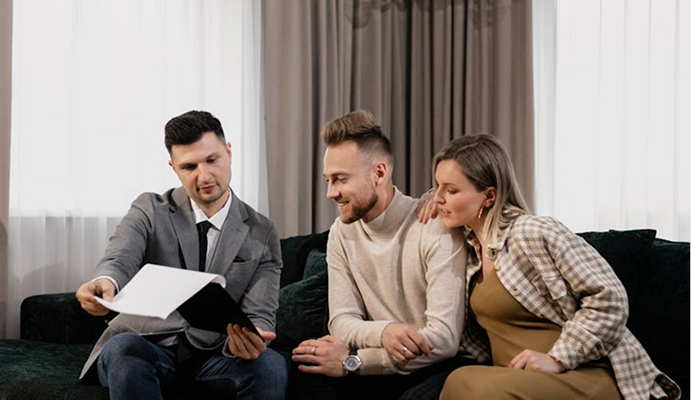 Financial advisor discussing investment strategy with a young couple in a professional setting