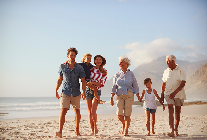 Multi-generational family walking together on the beach, symbolizing the diverse clients served by Point2 Capital Partners