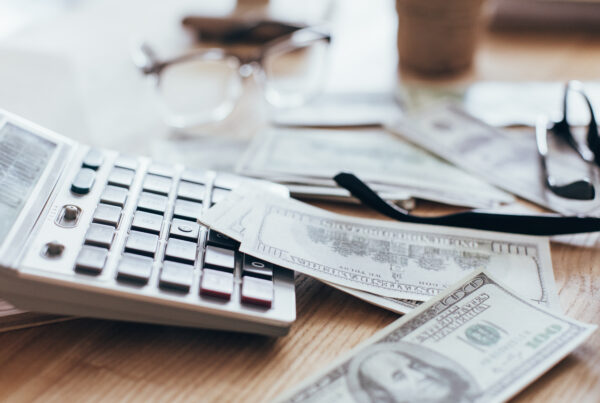 Close up view of money and calculator lying at workplace